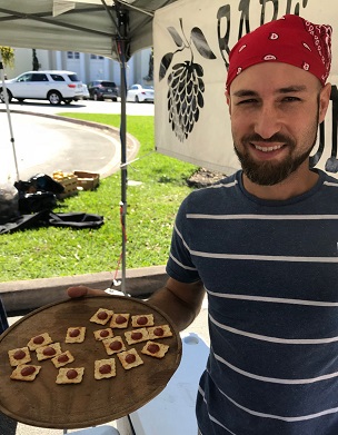 Jorge Zaldivar of PG Tropicals serving Redland guava tastes at the Coral Gables farmers market