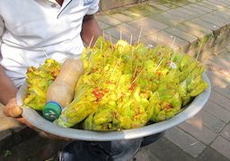 A hog plum (Spondias mombin) served as a snack with chilli powder, Dhaka, Bangladesh