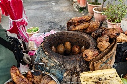 Taipei, Taiwan: A hawker offering his Sweet Potatoes in front of Shilin MRT Station